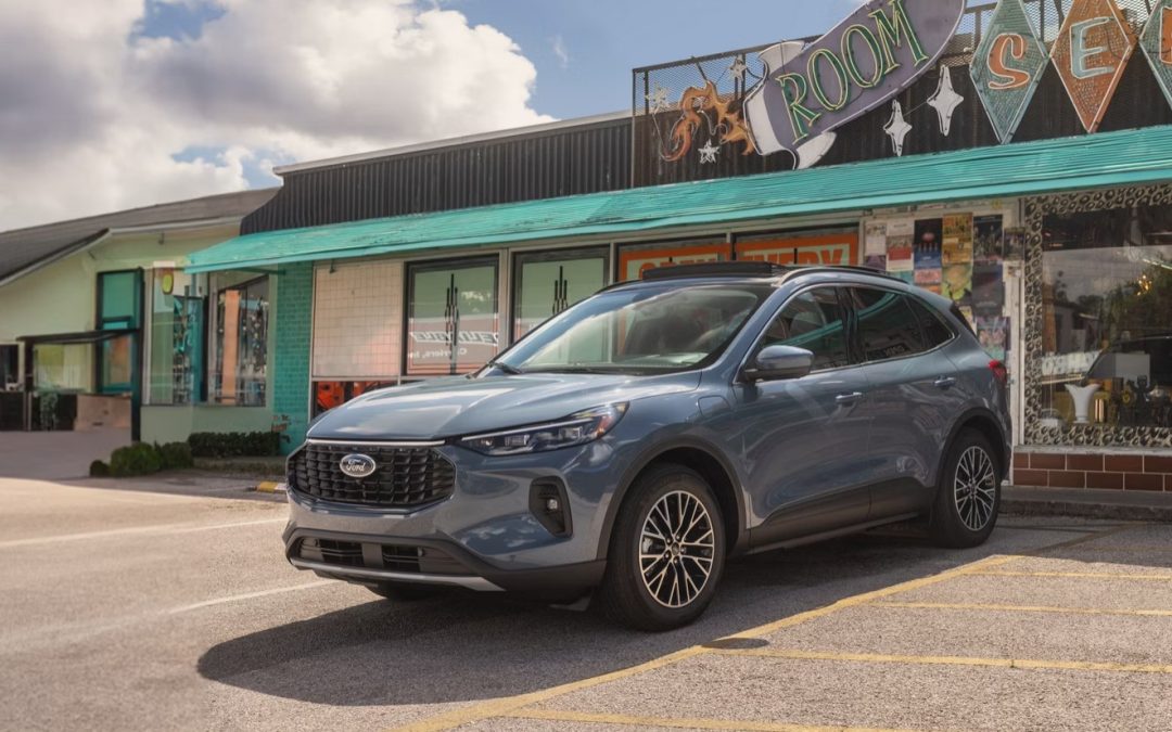 Blue 2026 Ford Escape Active SUV parked outside a roadside storefront
